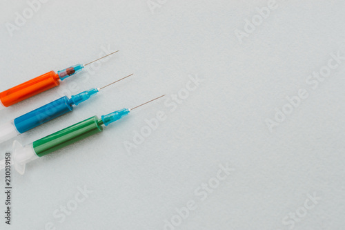 Three syringes on a light background. Cancer Cure Concept