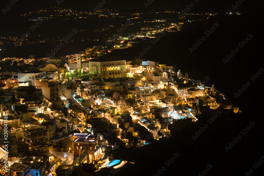 Fira town aerial view at night time, Santorini.