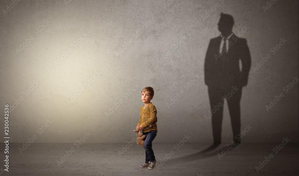 Little boy imagine that he will be businessman and illustrating his future in a big shadow
Little boy imagine that he will be businessman and illustrating his future in a big shadow