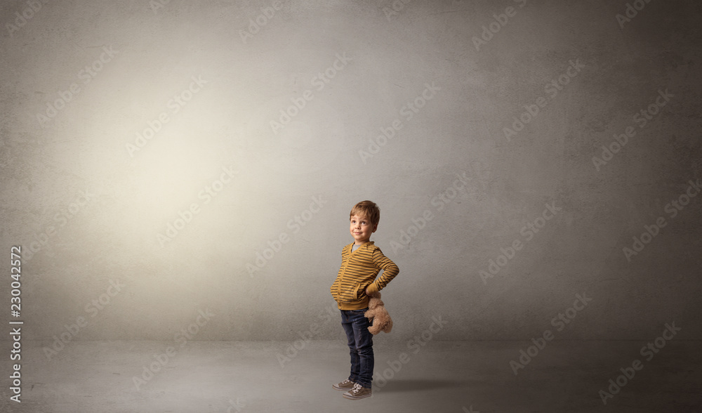 Little waggish kid staying alone in a big empty room with his plush
Little waggish kid staying alone in a big empty room with his plush