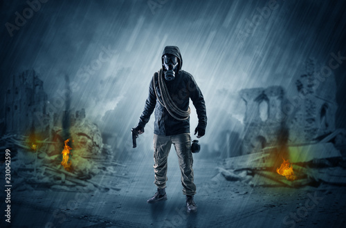 Destroyed place after a catastrophe with man in gas mask and weapon on his hand © ra2 studio