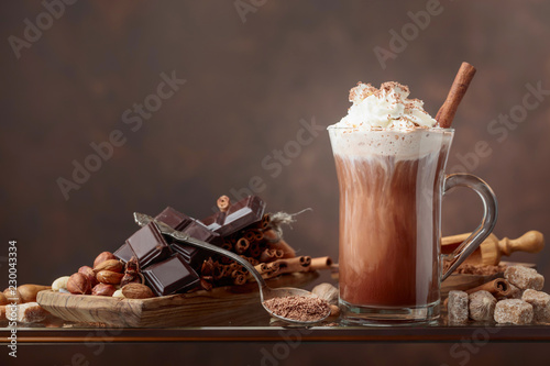 Hot chocolate with cream, cinnamon, chocolate pieces and various spices.