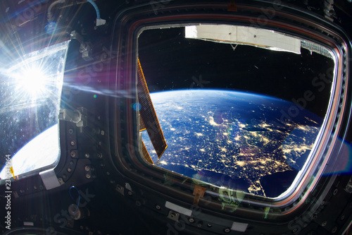 Fototapeta Naklejka Na Ścianę i Meble -  Collage image with huge US at night with city lights from the outer space from the ISS window. Elements of this image furnished by NASA.