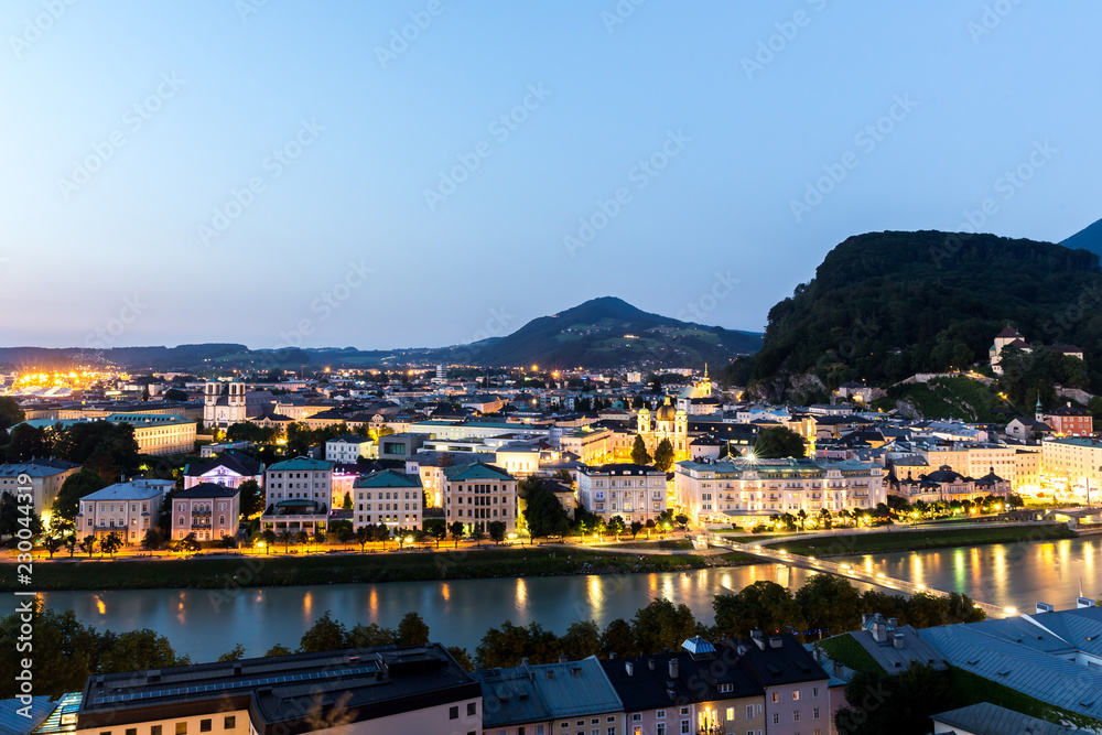 Salzburg Cathedral and famous Festung Hohensalzburg illuminated in  twilight