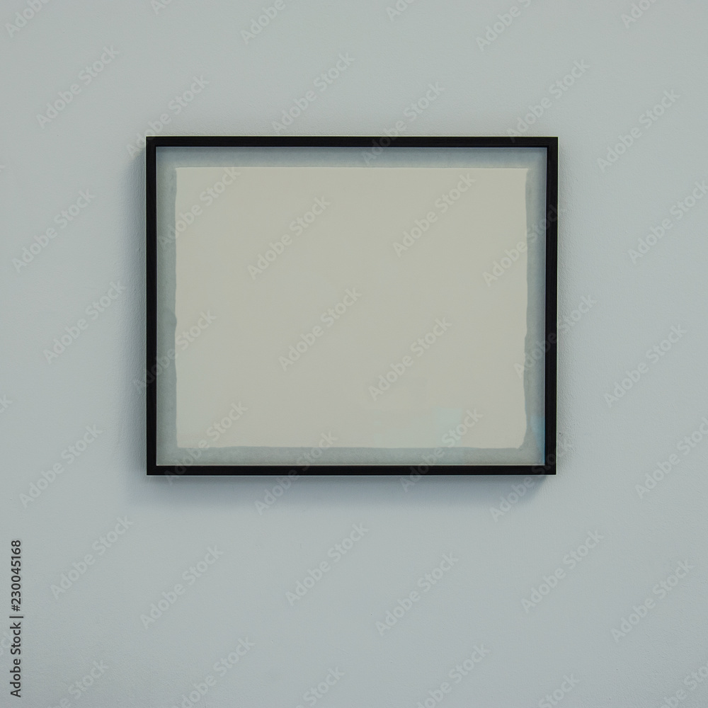 baguette frame with a white blank sheet on the wall. baguette frame with a white blank sheet on the wall.