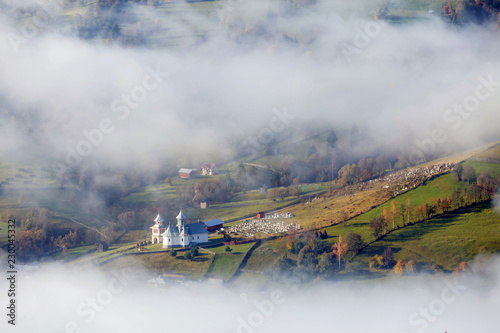 Foggy autumn morning above the traditional romanian cottages