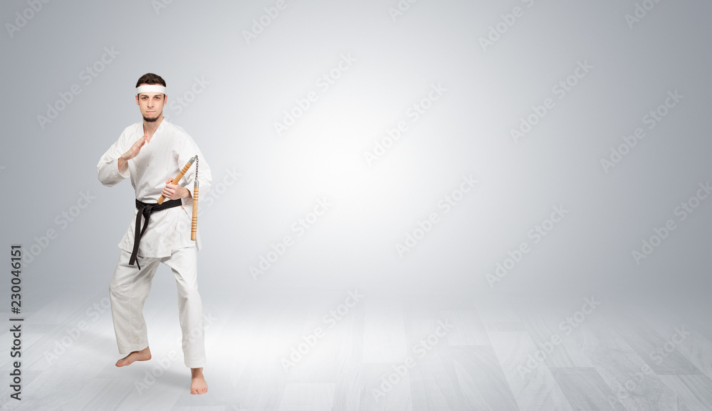 Young kung-fu trainer fighting in an empty space
Young kung-fu trainer fighting in an empty space