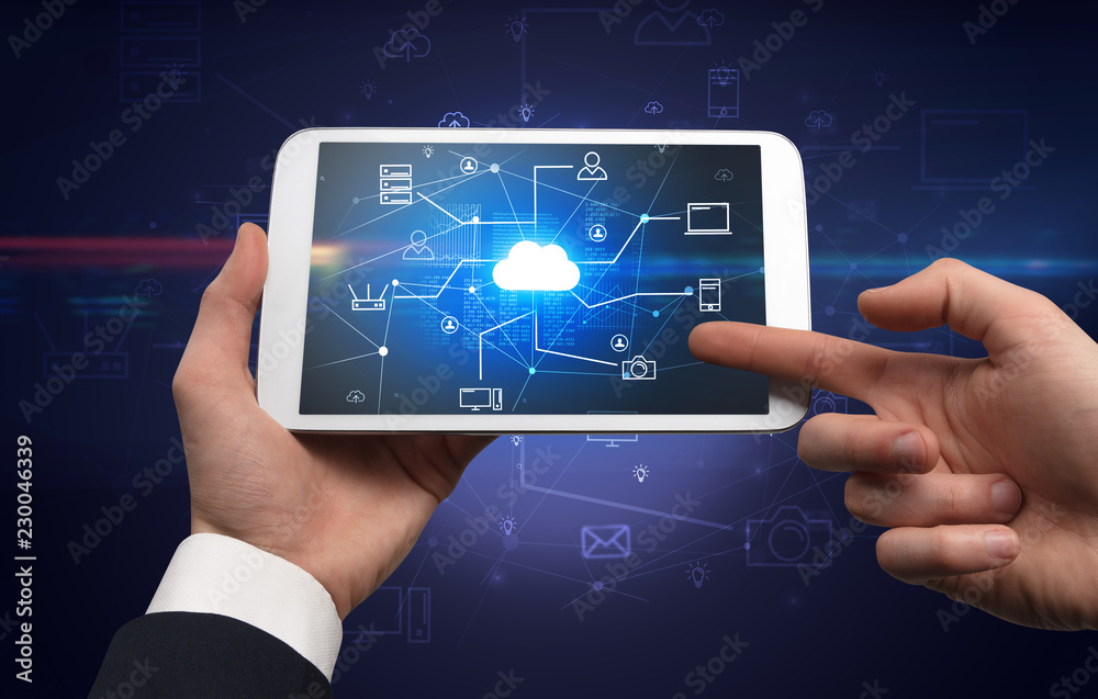 Obraz premium First person view of a hand using tablet with cloud office concept 