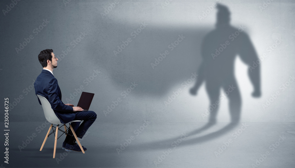 Humble businessman staying and offering stuffs to a superhero shadow
Humble businessman staying and offering stuffs to a superhero shadow
