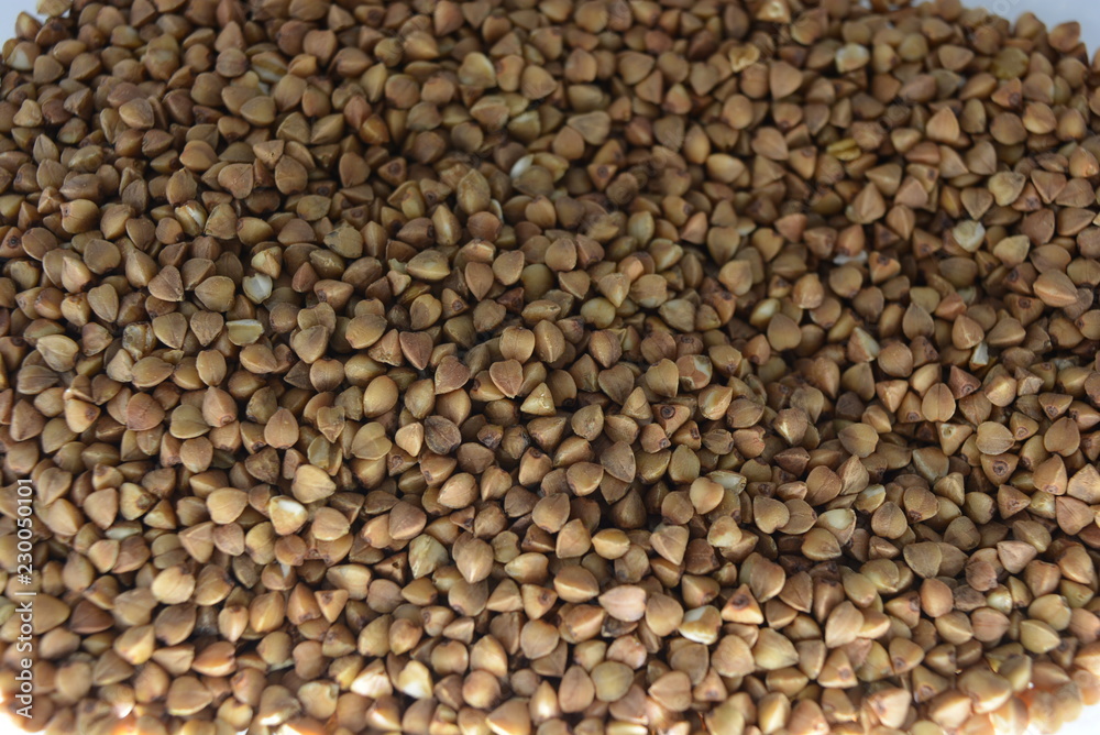 Fresh loose buckwheat groats, brown grains of buckwheat Fresh loose buckwheat groats, brown grains of buckwheat
