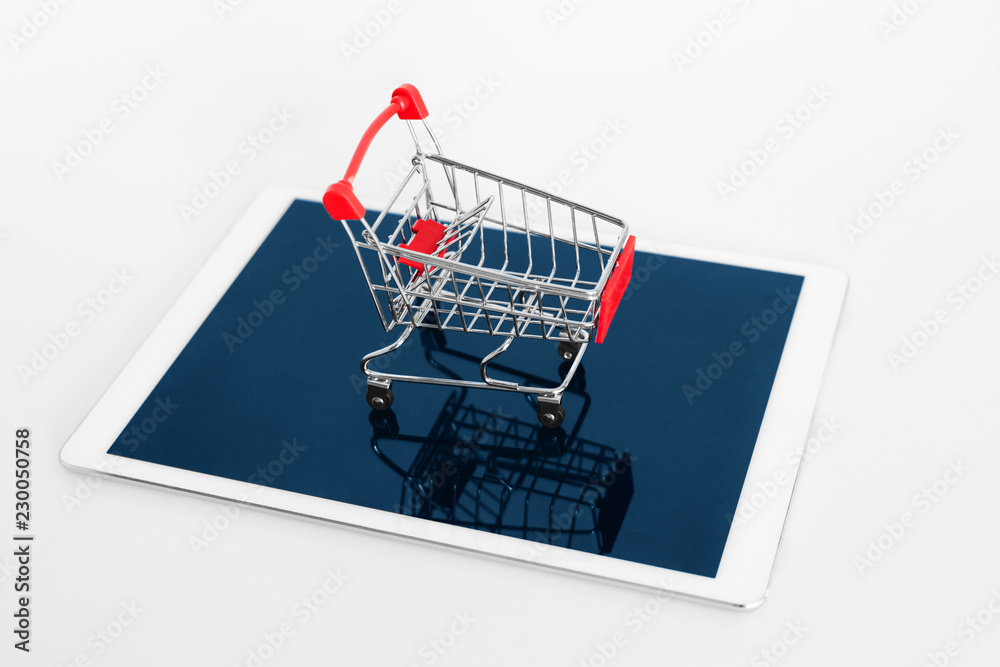 Empty shopping cart on digital tablet, isolated on white background. Online shopping