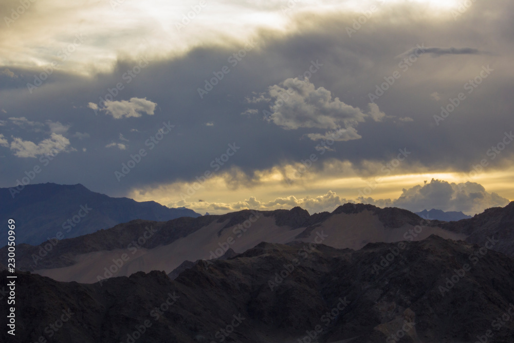 heavy sunset sky over the desert mountain ranges