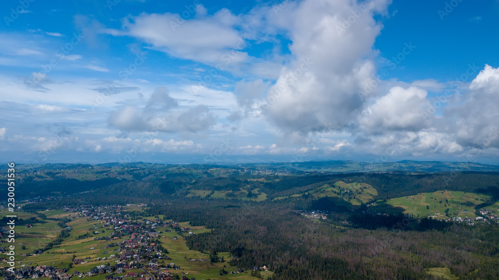Obraz premium Aerial view of endless lush pastures and farmlands of Ireland. Beautiful Irish countryside with emerald green fields and meadows. Rural landscape on sunset.