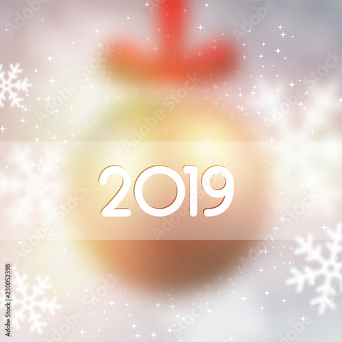 Blurred shiny 2019 New Year background with Christmas ball and snow.