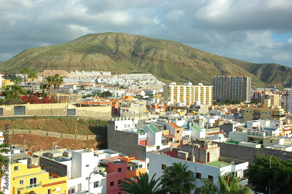 Small town and tourist resort in south-west coast of the island, in Arona Municipality with Montana de Guaza in the background, Los Cristianos, Tenerife, Canary Islands, Spain