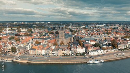 Panoramic view of the Dutch medieval city of Deventer in The Netherlands seen from the other side of the river IJssel with central the principal church at the market square and wider landscape