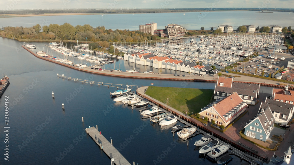 Recreational port with boats and boat houses with in the background Het Gooi lake in The Netherlands