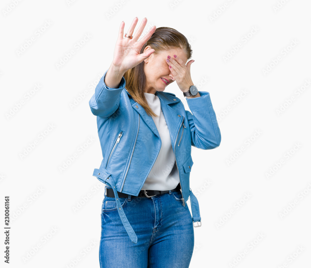 Beautiful middle age mature woman wearing fashion leather jacket over isolated background covering eyes with hands and doing stop gesture with sad and fear expression. Embarrassed and negative Beautiful middle age mature woman wearing fashion leather jacket over isolated background covering eyes with hands and doing stop gesture with sad and fear expression. Embarrassed and negative