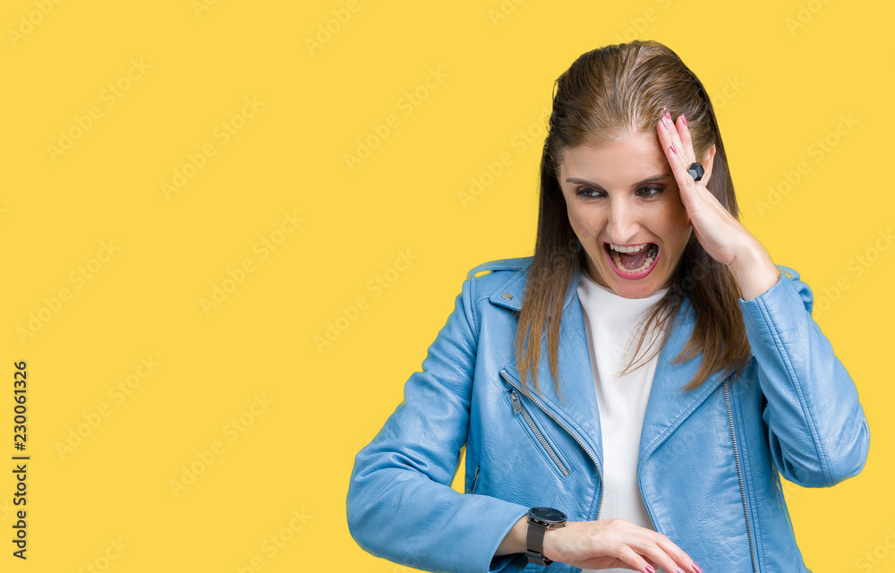 Beautiful middle age mature woman wearing fashion leather jacket over isolated background Looking at the watch time worried, afraid of getting late Beautiful middle age mature woman wearing fashion leather jacket over isolated background Looking at the watch time worried, afraid of getting late