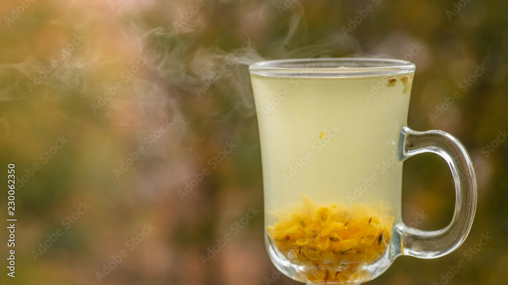 Hot Vitaminic healthy sea buckthorn tea in small glass glass with fresh raw sea buckthorn berries Hot Vitaminic healthy sea buckthorn tea in small glass glass with fresh raw sea buckthorn berries
