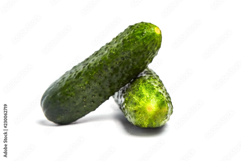Two green fresh gherkins isolated on white background Two green fresh gherkins isolated on white background