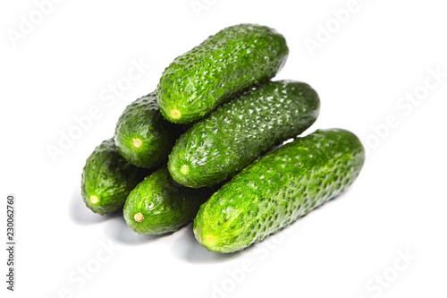 Pile of green fresh gherkins isolated on white background