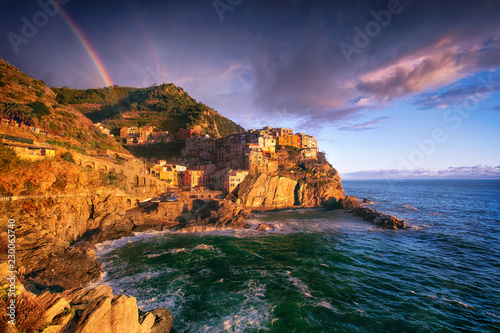Obraz na płótnie Manarola Village, Cinque Terre Coast, Liguria, Italy. The fishing village on the sea coast is a UNESCO World Heritage site. Landscape with a rainbow. w salonie