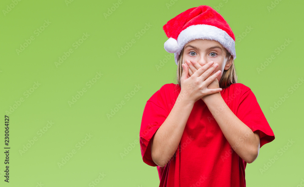 Young beautiful girl wearing christmas hat over isolated background shocked covering mouth with hands for mistake. Secret concept. Young beautiful girl wearing christmas hat over isolated background shocked covering mouth with hands for mistake. Secret concept.