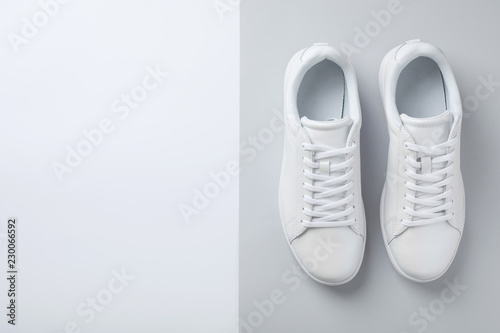 Pair of trendy sneakers on light background, flat lay. Space for text