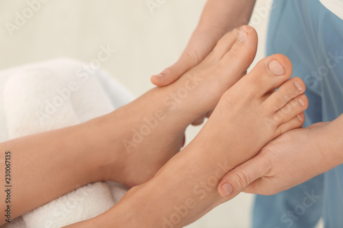 Woman receiving leg massage in wellness center, closeup