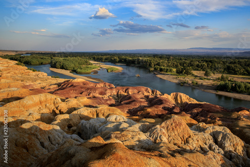 Rainbow Beach, Five Colored Hills scenic area, an oasis in the desert near Burqin. Buerjin, Altay, Xinjiang Province, China. Colorful hills and the beautiful Irtysh River. Exotic Asia Landscapes photo