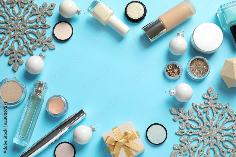 Flat lay composition with makeup products and Christmas decor on color background. Space for text Flat lay composition with makeup products and Christmas decor on color background. Space for text