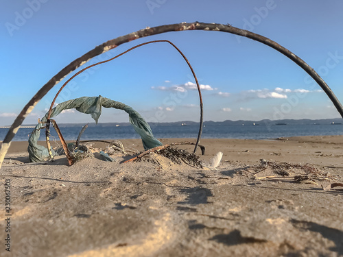 Trash architecture in the beach sand