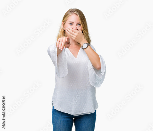 Beautiful young elegant woman over isolated background Laughing of you, pointing to the camera with finger hand over mouth, shame expression