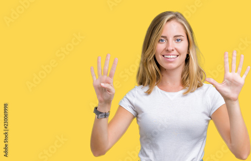 Beautiful young woman wearing casual white t-shirt over isolated background showing and pointing up with fingers number nine while smiling confident and happy.