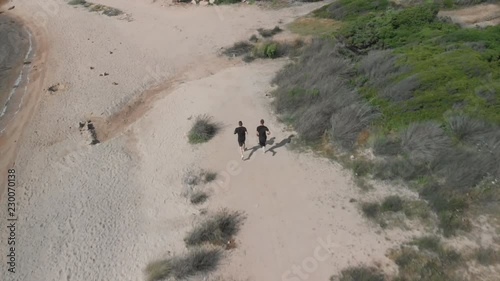 Aerial View of Two Athletic Men Running on the Beach 1