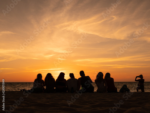 Group of people silhouette on the sunset beach time