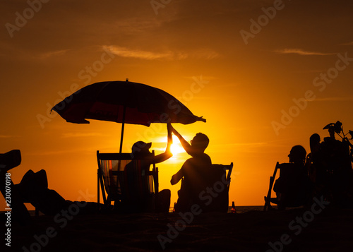 People rest on the sunset beach