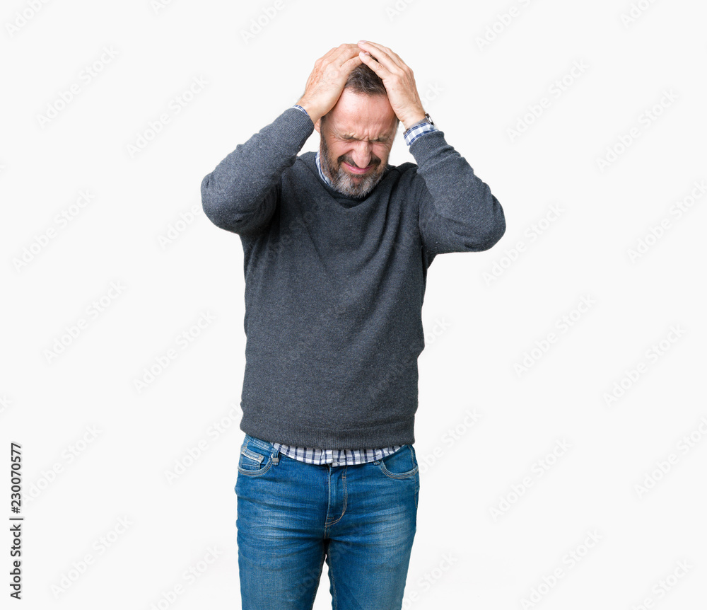 Handsome middle age senior man wearing a sweater over isolated background suffering from headache desperate and stressed because pain and migraine. Hands on head. Handsome middle age senior man wearing a sweater over isolated background suffering from headache desperate and stressed because pain and migraine. Hands on head.