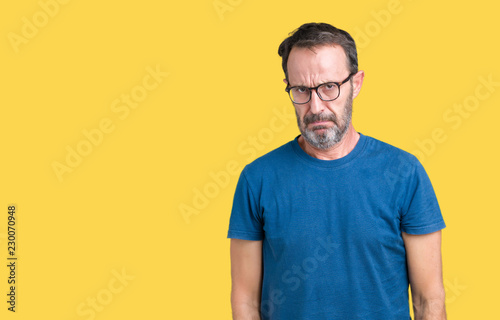 Handsome middle age hoary senior man wearin glasses over isolated background skeptic and nervous, frowning upset because of problem. Negative person.