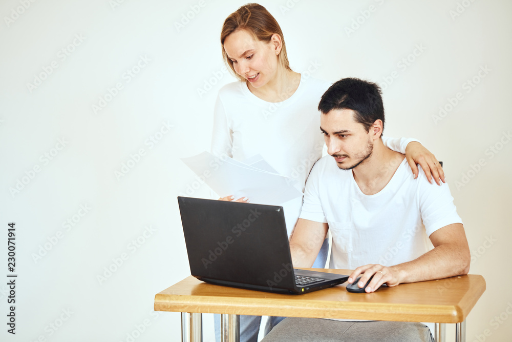 Frustrated couple, high taxes, reading mail paper from bank at home, financial problems, domestic bills Frustrated couple, high taxes, reading mail paper from bank at home, financial problems, domestic bills