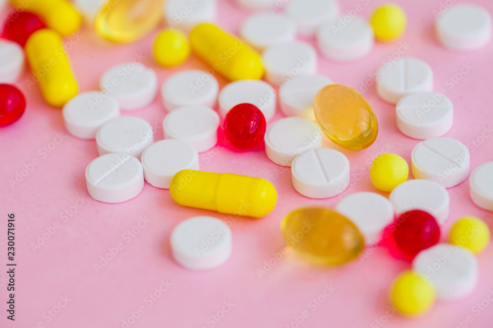 Close up of pills. Dietary supplements. Variety pills. Vitamin capsules on pink background Close up of pills. Dietary supplements. Variety pills. Vitamin capsules on pink background