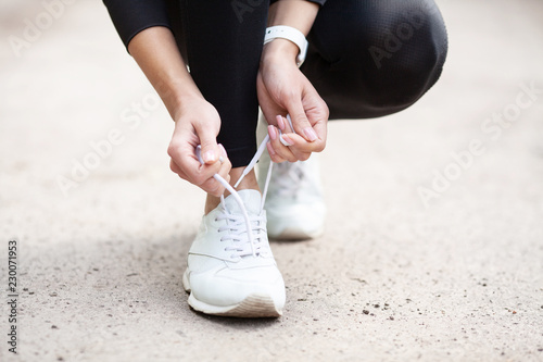 Sneakers Problem. Female Runner Tying Her Shoes Preparing For a jog