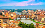 Aerial view of medieval stone bridge Ponte Vecchio over Arno river in Florence, Tuscany, Italy. Florence cityscape. Florence architecture and landmark.