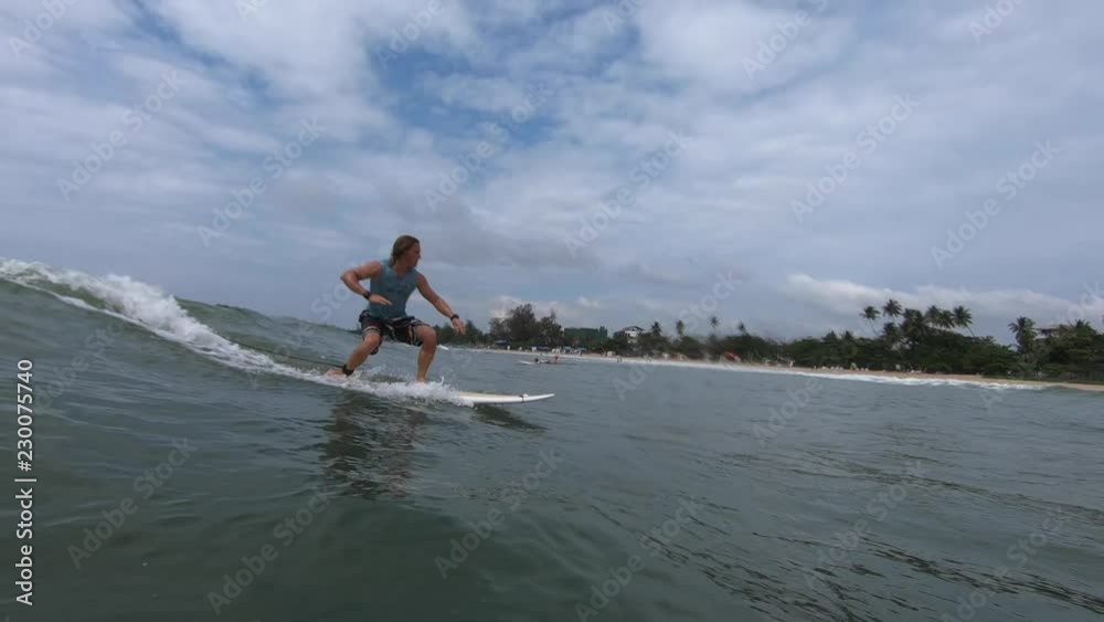 Amateur surfer rides the ocean wave and falls Amateur surfer rides the ocean wave and falls