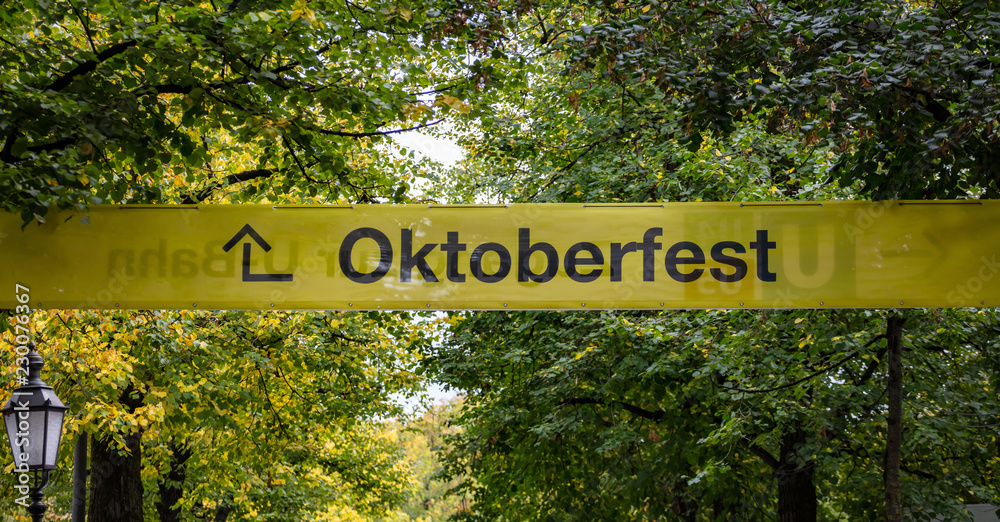 Oktoberfest, Munich. Germany. Yellow informative sign, text oktoberfest, green trees background