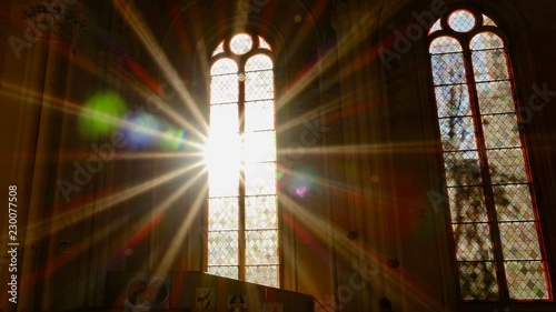 Sonnenstrahlen scheinen durch ein altes Kirchenfenster