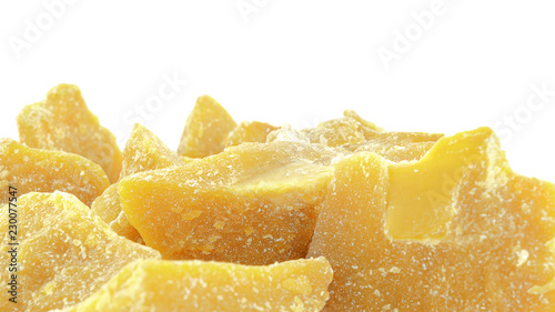 Pieces of natural beeswax are isolated on a white background photo