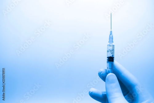 Medical hand glove blue molding vial vaccine hypodermic needle syringe injection treatment.Lab since test immunization and vaccination concept.drug insulin care prevention  diabetes disease hospital. photo