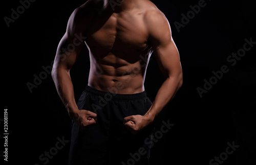 The human with muscular torso on black background,show fit and firm body,strong muscle